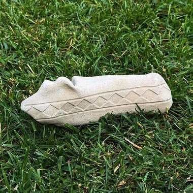 Cast calcaneus bone carved with a design contributed by the Choctaw Nation of Oklahoma