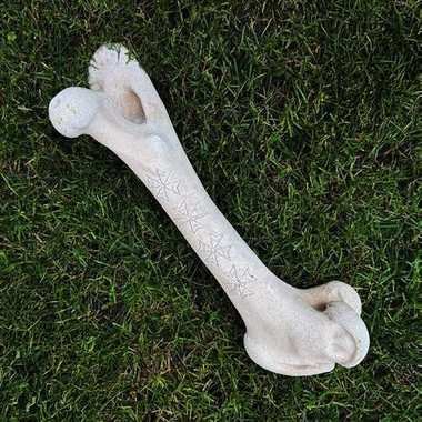 Cast femur bone carved with a design by Brent Greenwood