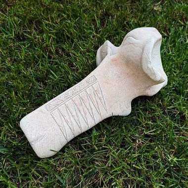 Cast lumbar vertebra bone carved with a design by Tom Farris